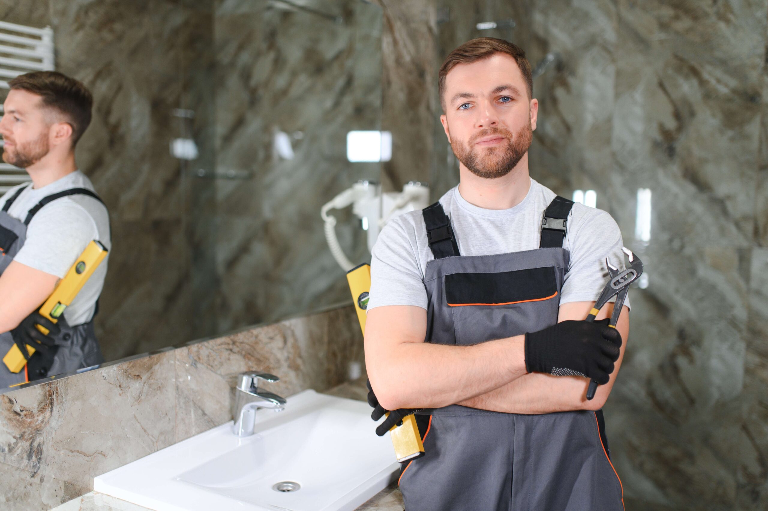 a-man-is-setting-the-washbasin-over-the-cabinet
