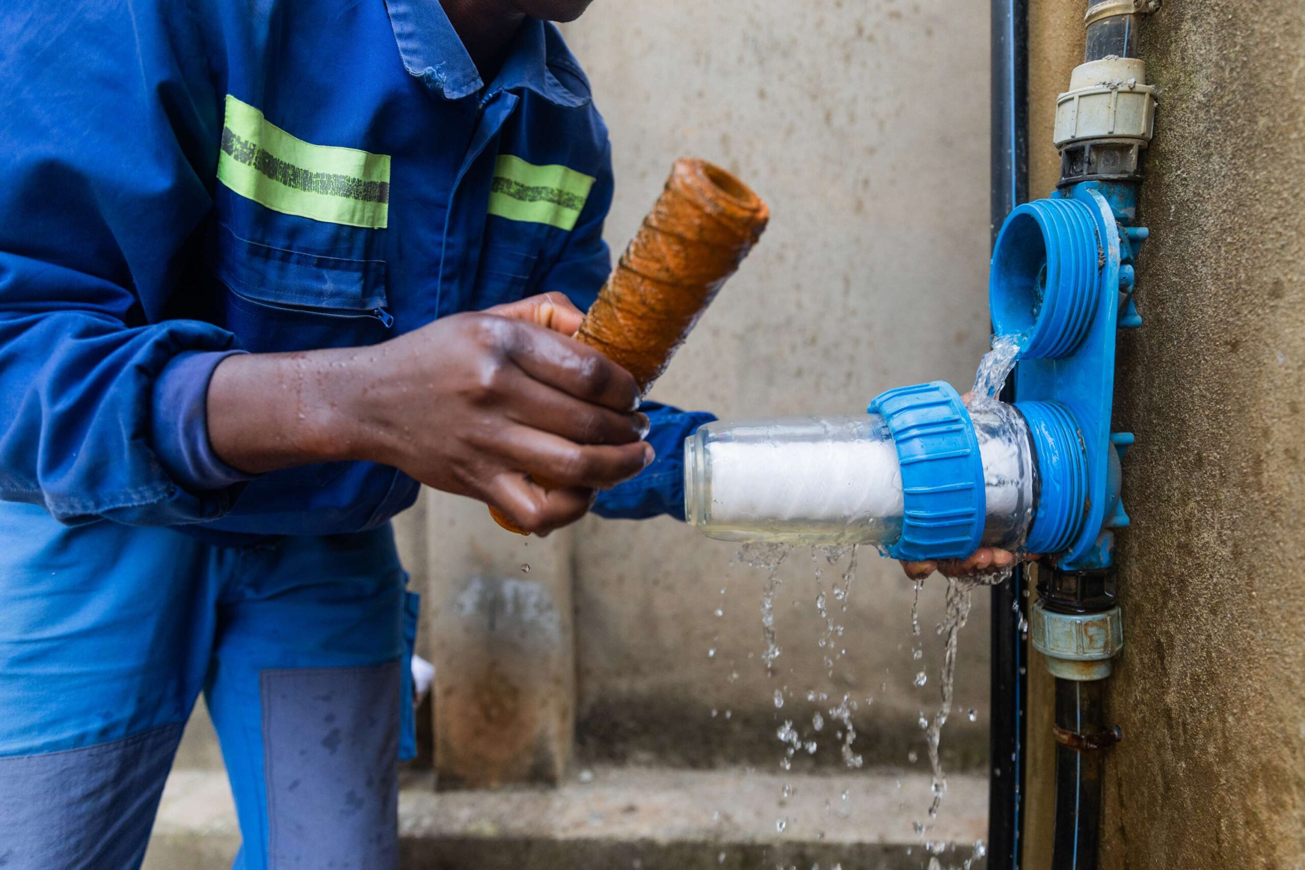 closeup-of-african-plumber-showing-one-dirty broken pipe