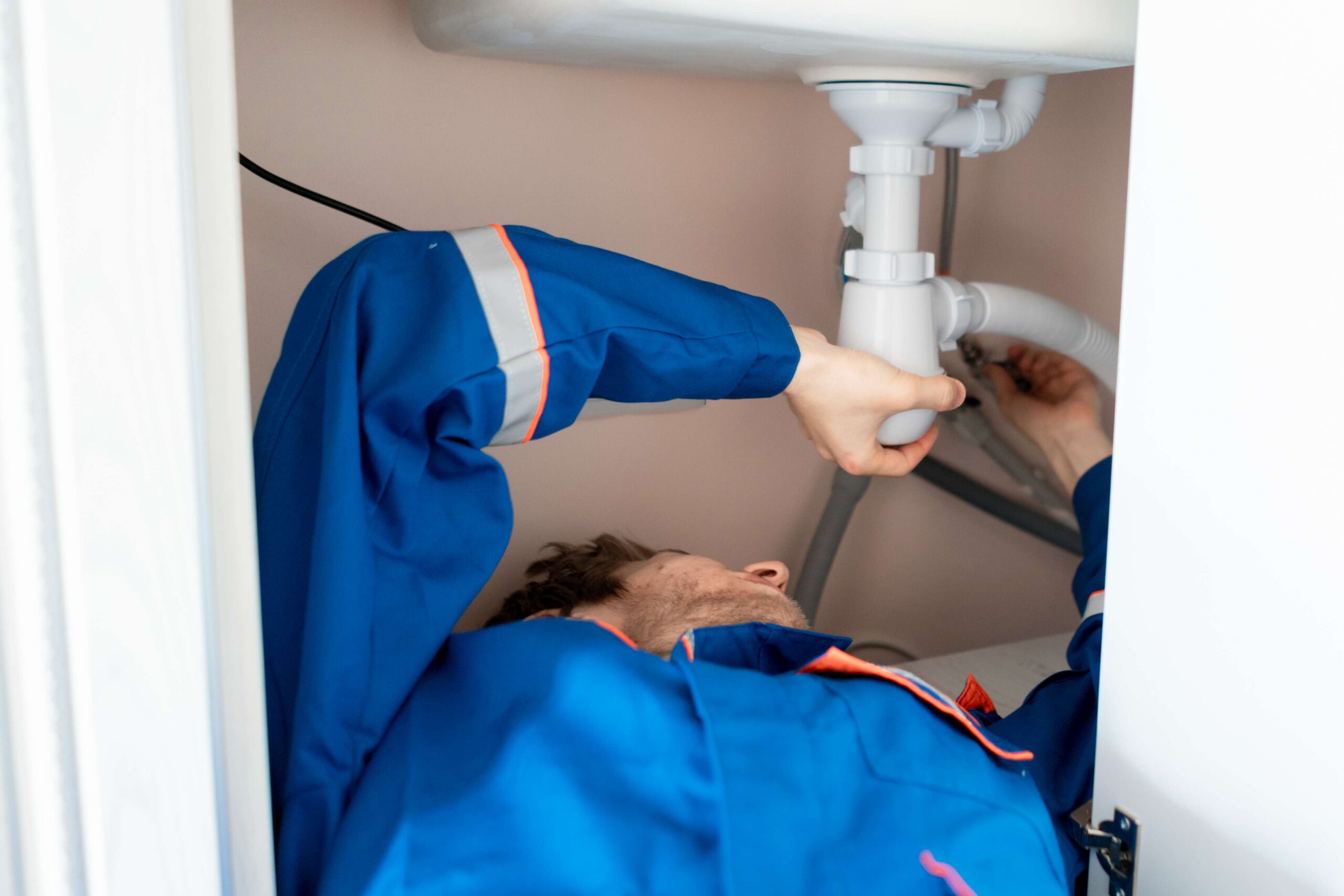 plumber-in-blue-uniform-lying-in-the-kitchen