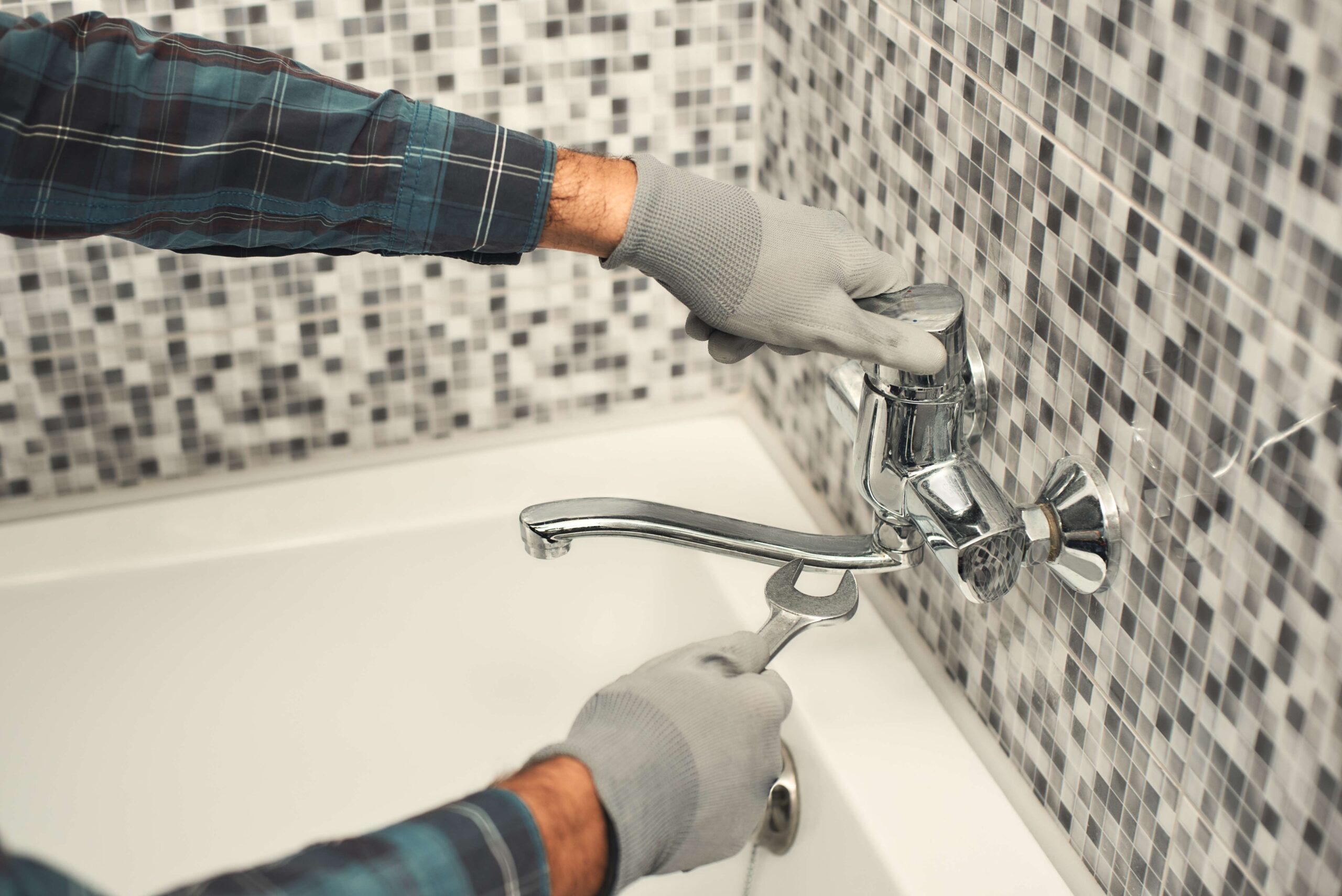http://plumber-repairing-a-tap-in-the-bathroom