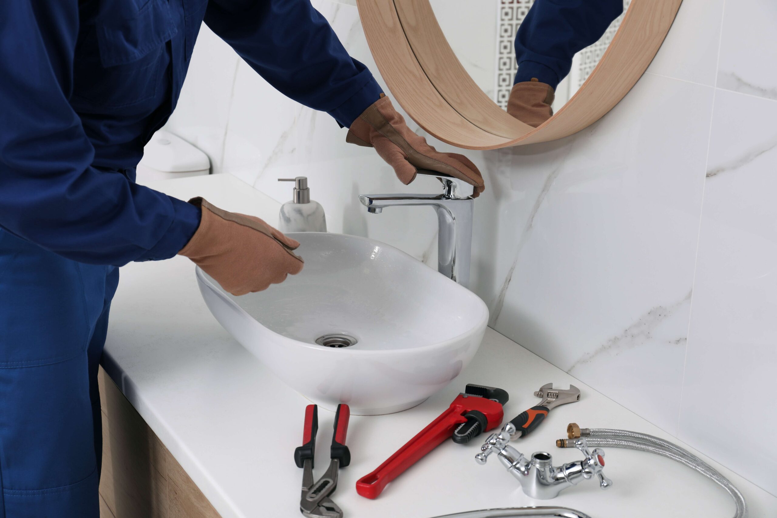 http://professional-plumber-checking-water-tap-in-bathroom